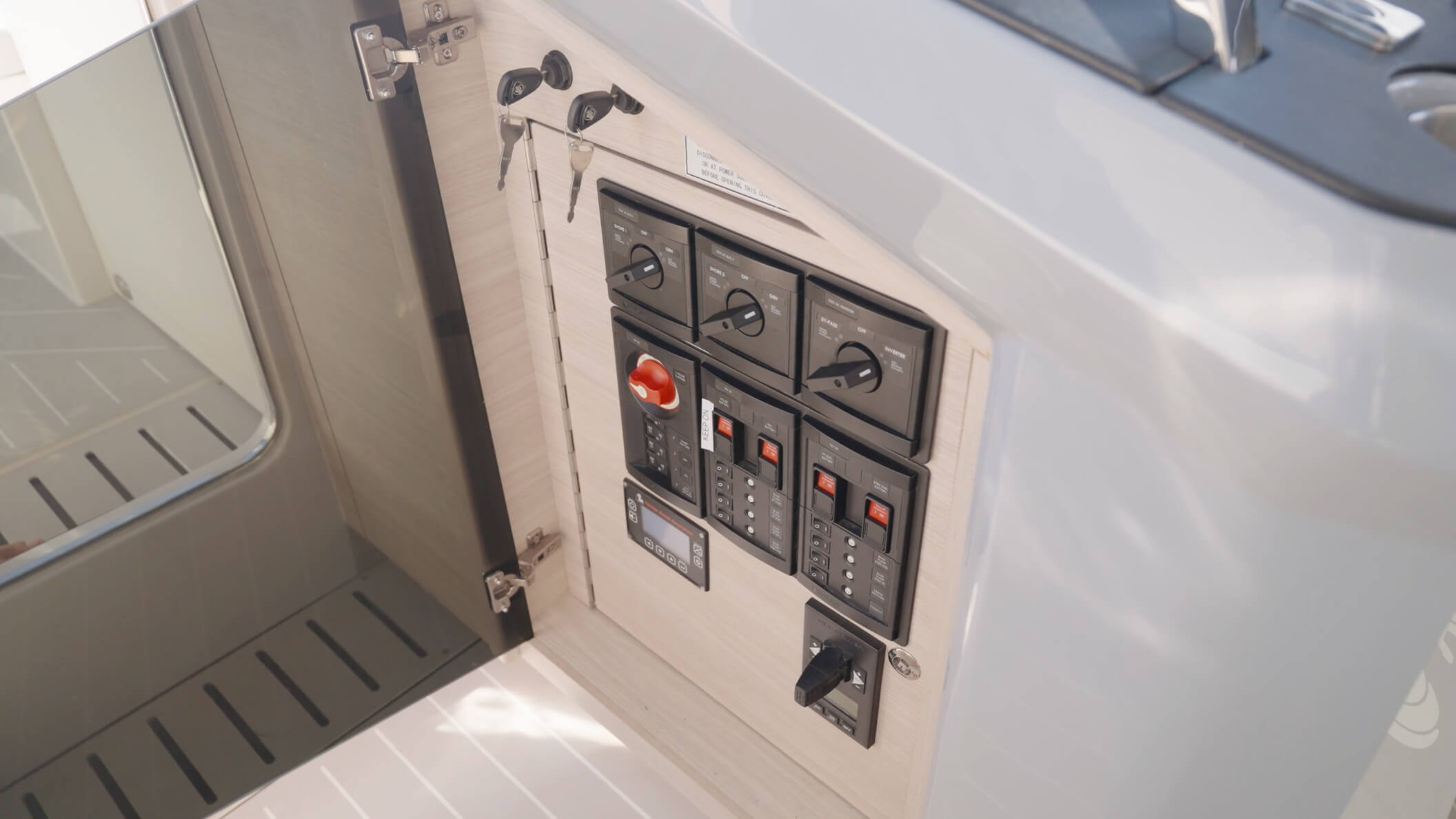Aquila 42 Coupe Power Catamaran 120v AC electrical panel, DC breakers, and Fischer Panda generator controls