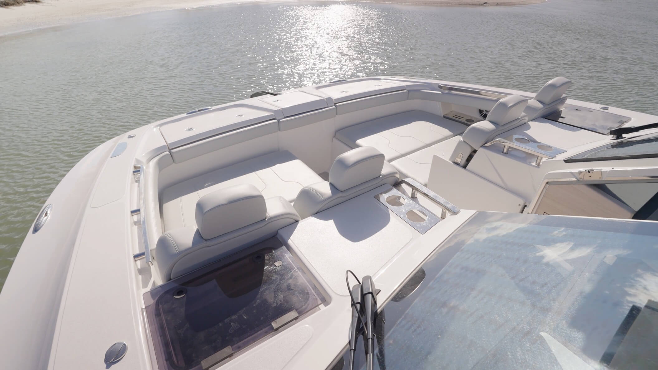 Aquila 42 Coupe Power Catamaran located just aft of the seat backs are cup holders and safety hatches leading from and to the staterooms on each side