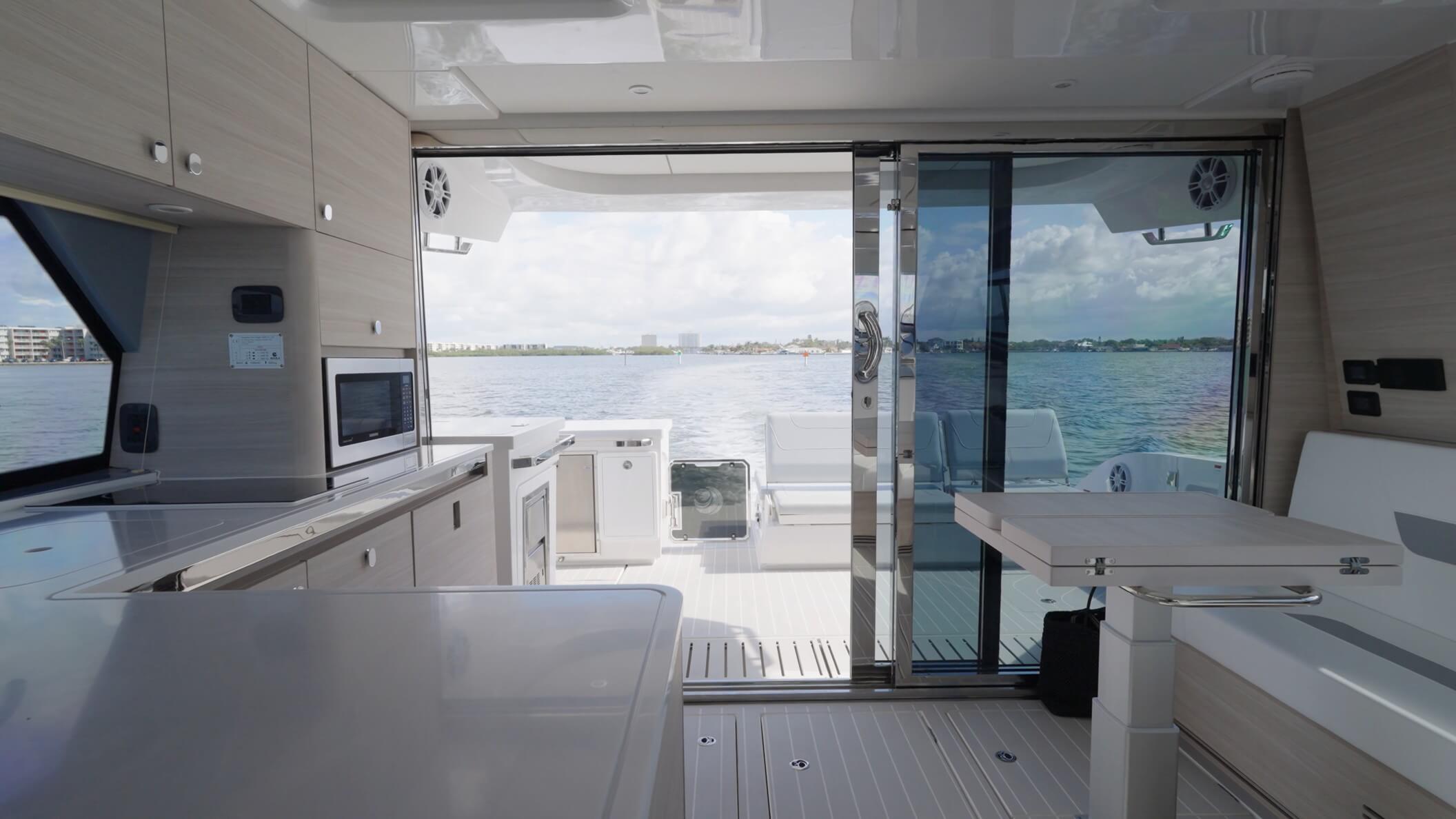 Aquila 42 Coupe Power Catamaran triple glass doors from cockpit and aft section