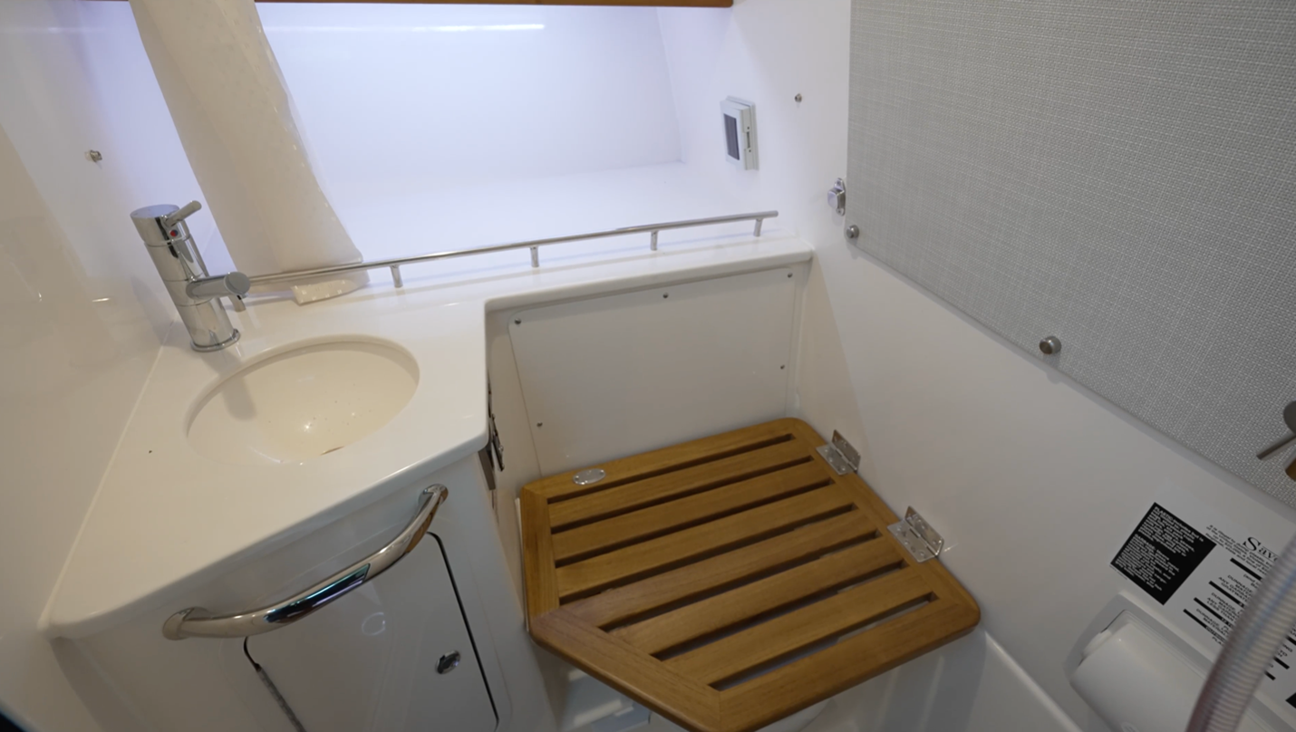 Boston Whaler 350 Realm The private wet head offers a shower as well. The toilet is under the hinged teak seat.