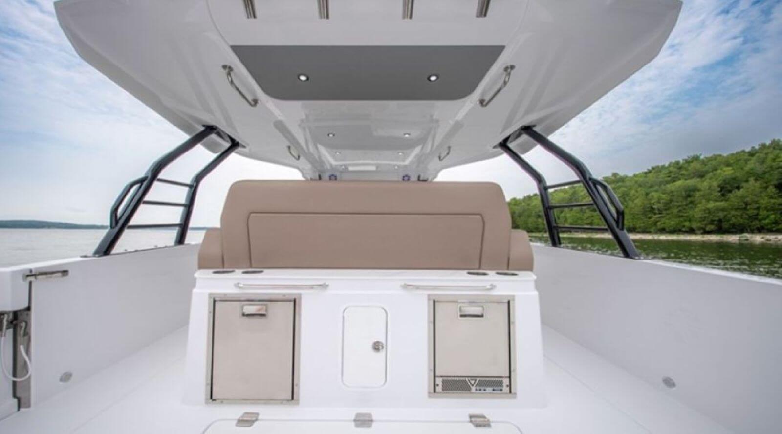 Cruisers 38 VTR aft side of the bench features a refrigerator, ice maker, and storage