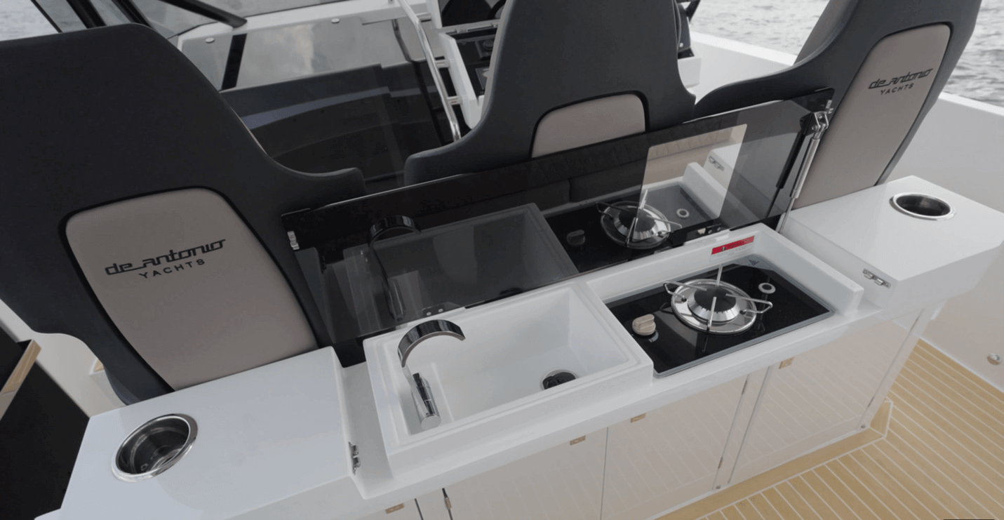 De Antonio D32 Open galley with sink, single burner stove which can be ordered as an optional electric cooktop, and storage cabinets below including a refrigerator