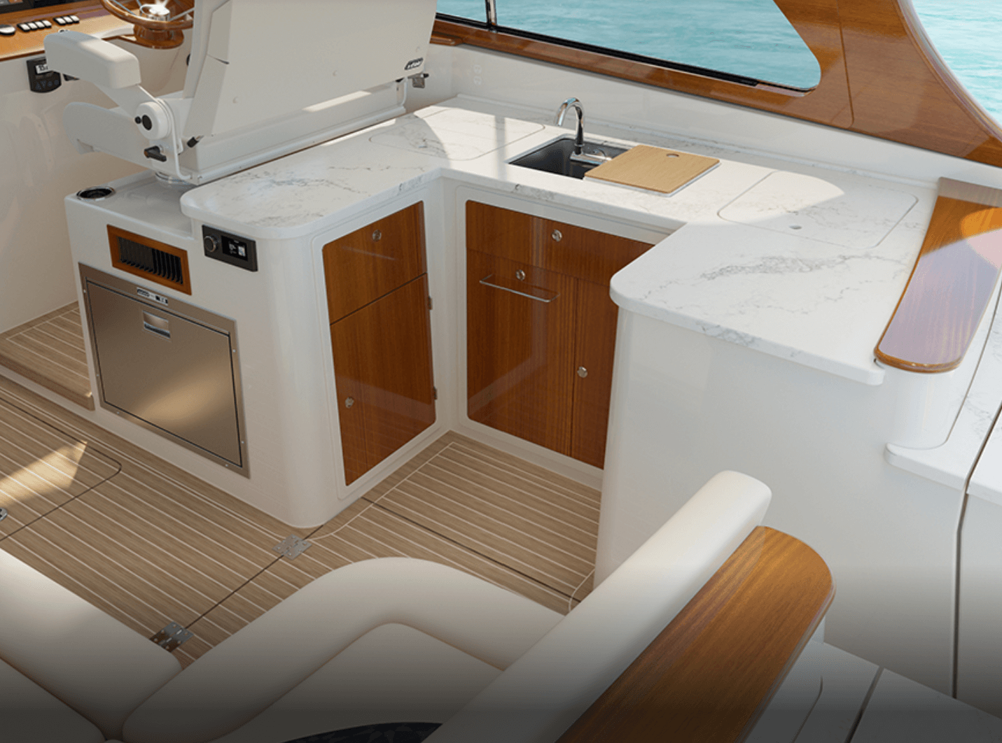 Hinckley 41 kitchenette includes a refrigerator drawer under the helm seat, sink and cooktop