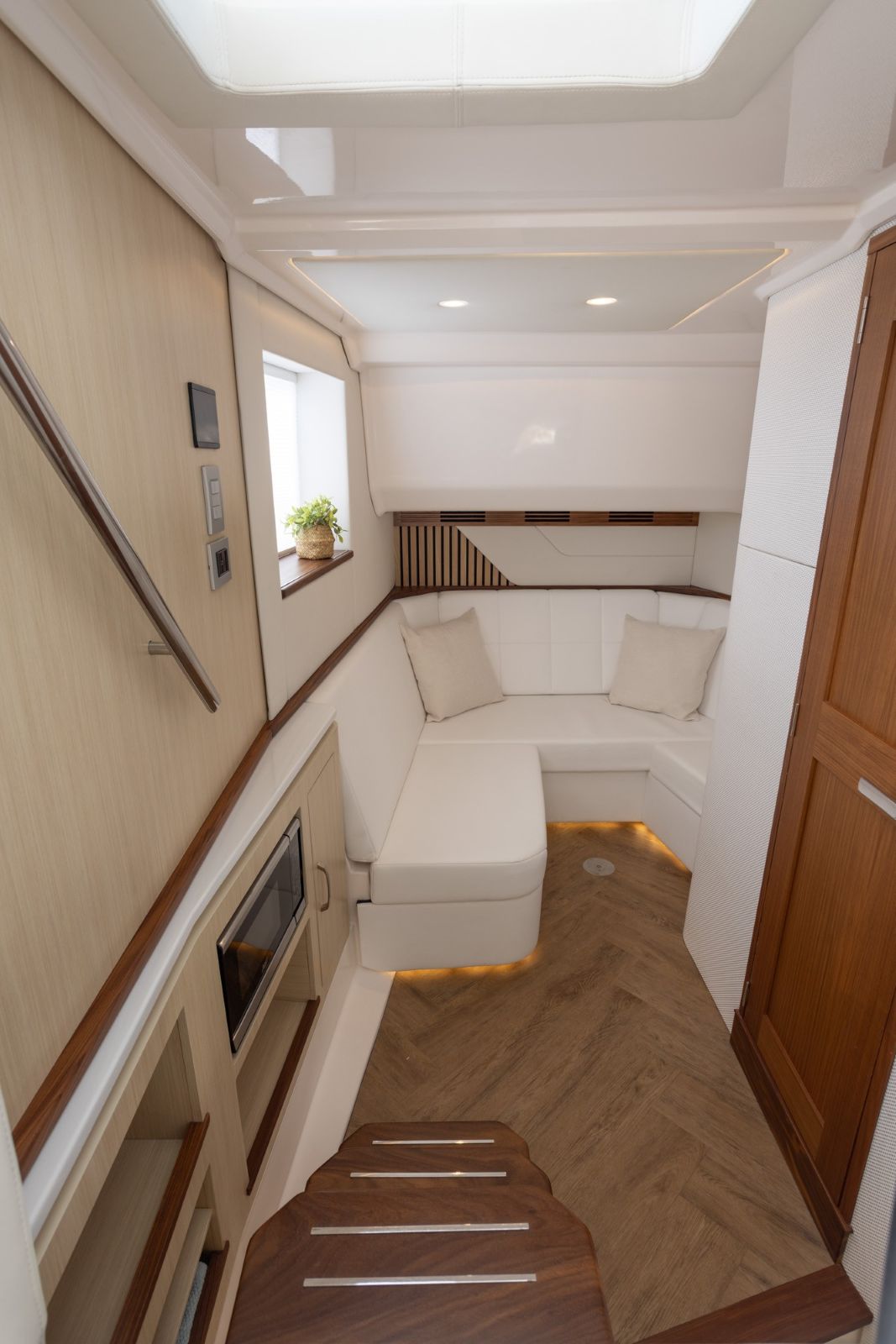 Regal LX43 forepeak quarters offer U-shaped seating space the converts to a berth