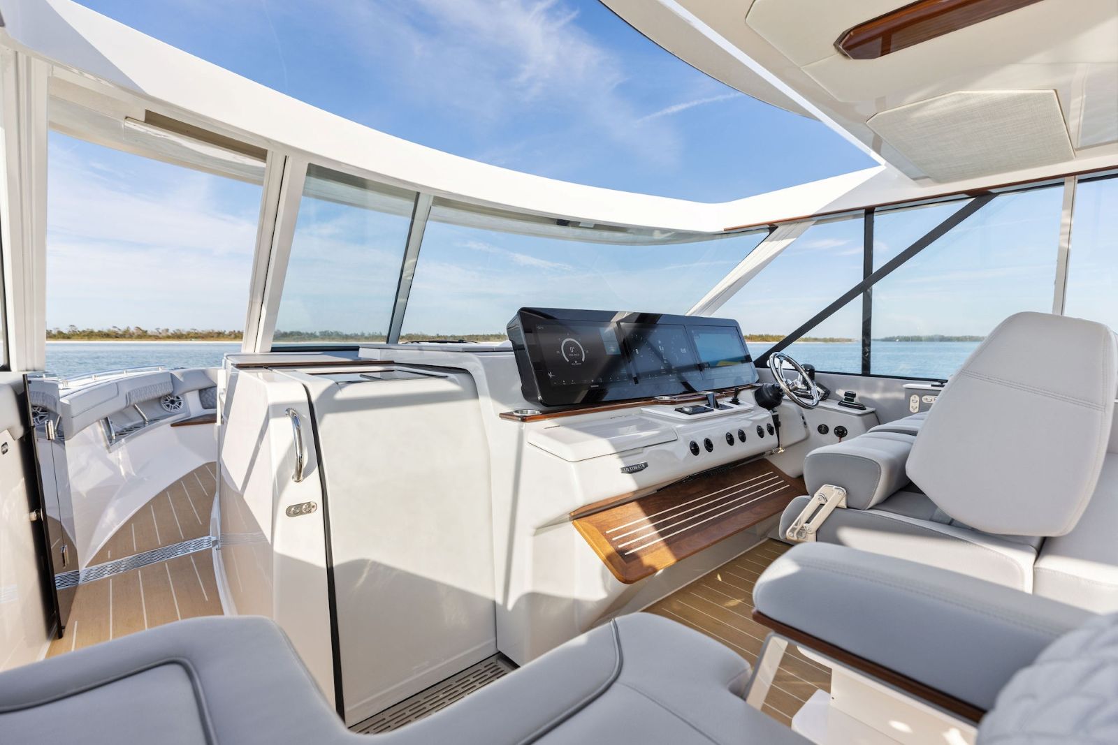 Regal LX43 helm area with large windows and open sunroof