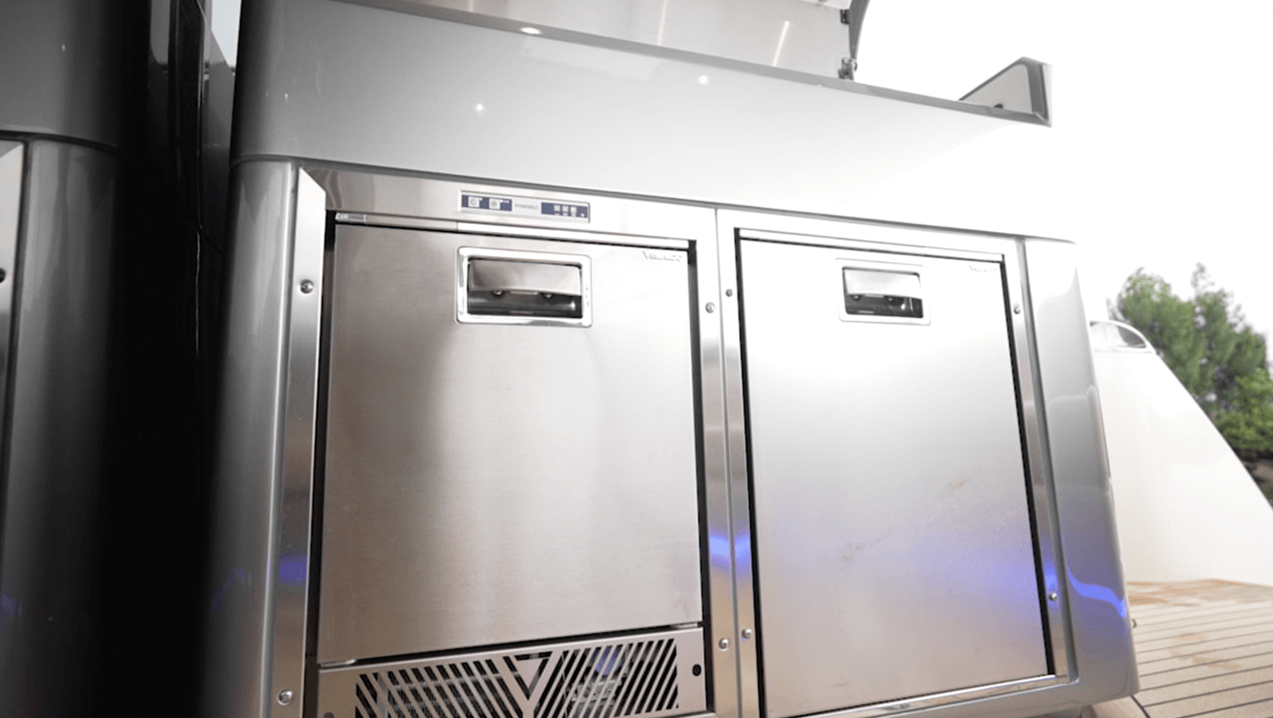 Icemaker (left) and refrigerator (right) under the grill and sink