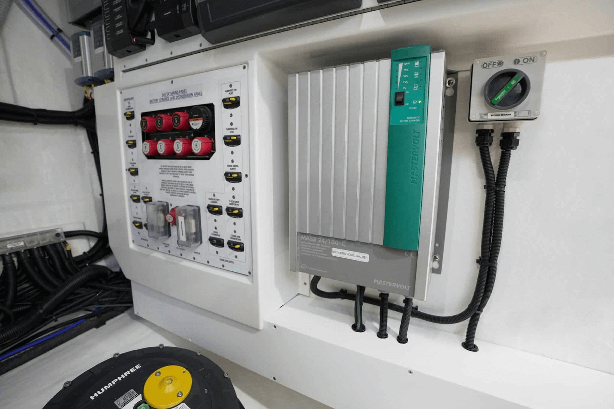 The AC power breaker panel is easily accessed in the engine room. In this instance it is located next to the Mastervolt battery charger system which is installed into Riviera motor yachts