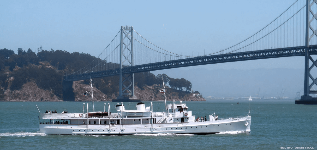 The USS Potomac under power near the Oakland Bay Bridge