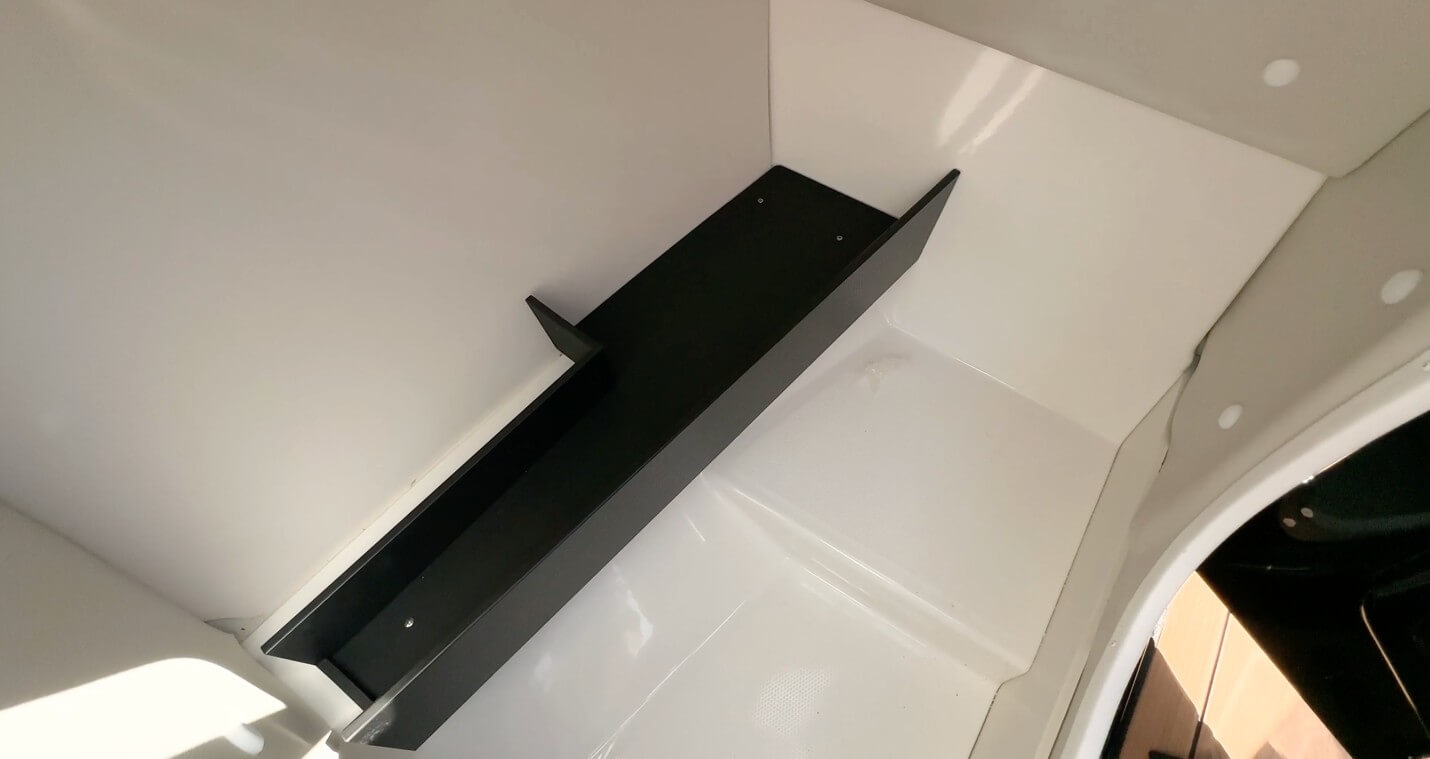 The port side of the console houses this large storage space which can easily hold a porta-potti unit.