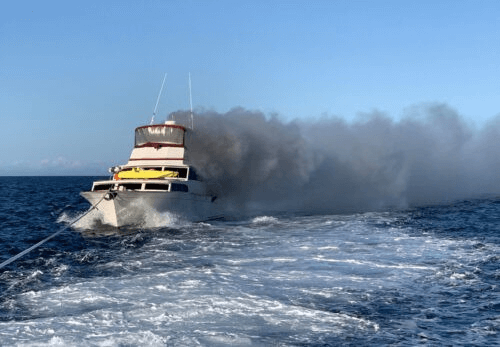 Boat on fire with lots of smoke