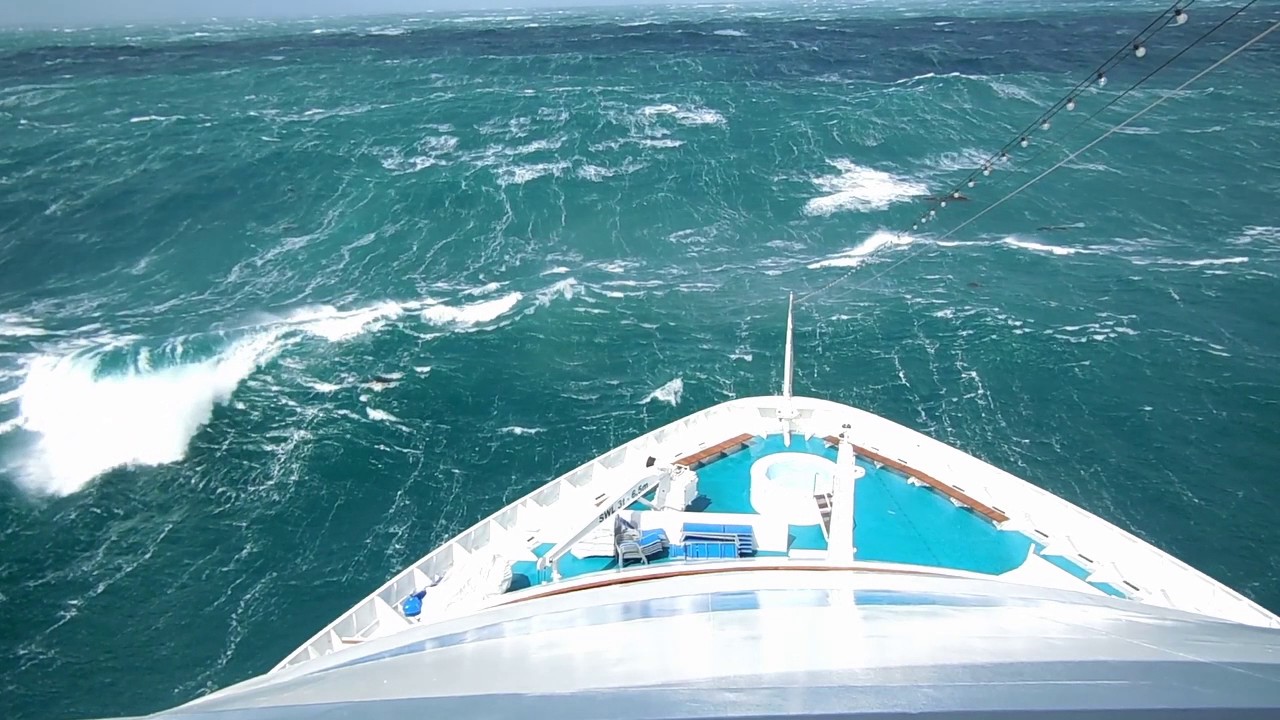 Yacht at Cape Horn, boat in huge waves