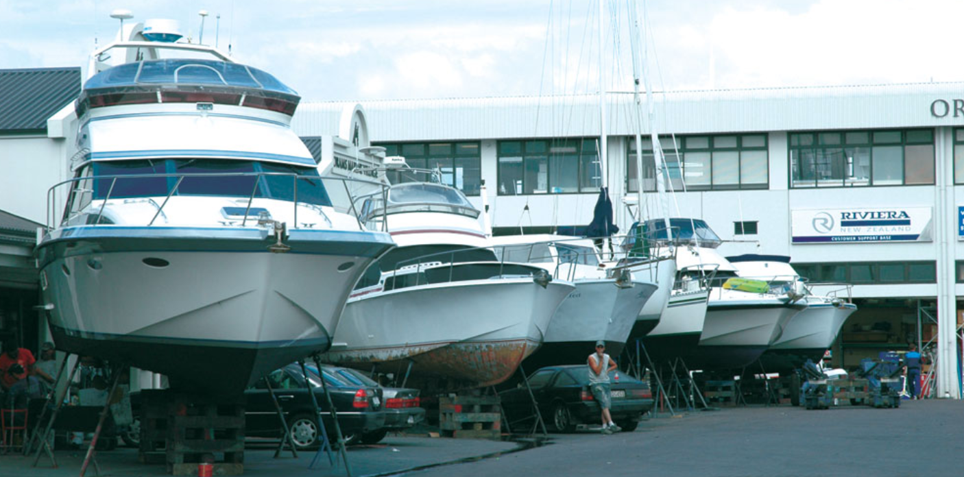 boats on stands, boats in parking lot