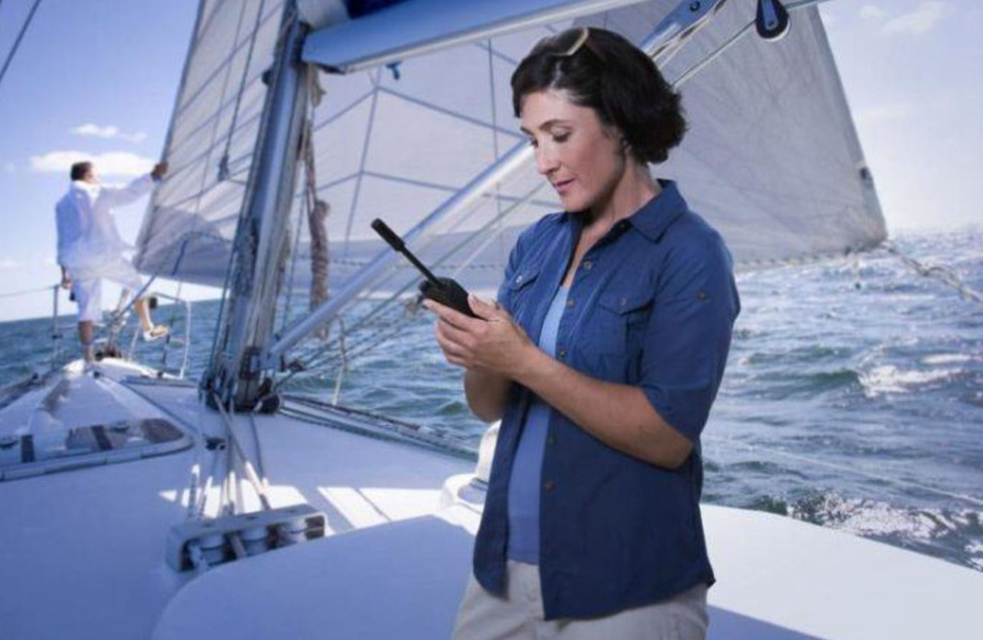 woman with sat phone, sat phone on a sailboat