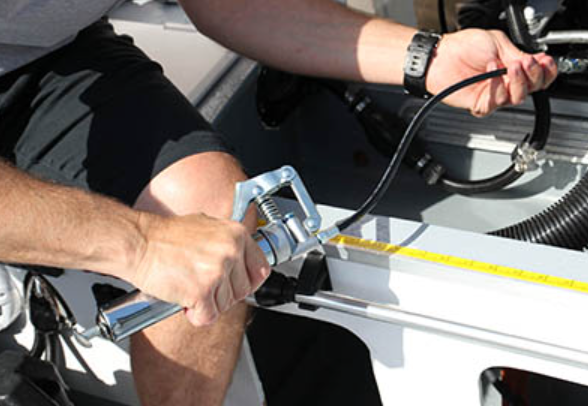 lubricating cable steering on a boat, adding fluid