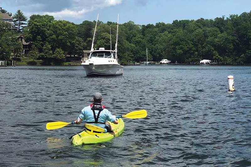 kayak meets powerboat, kayaker, boat wakes