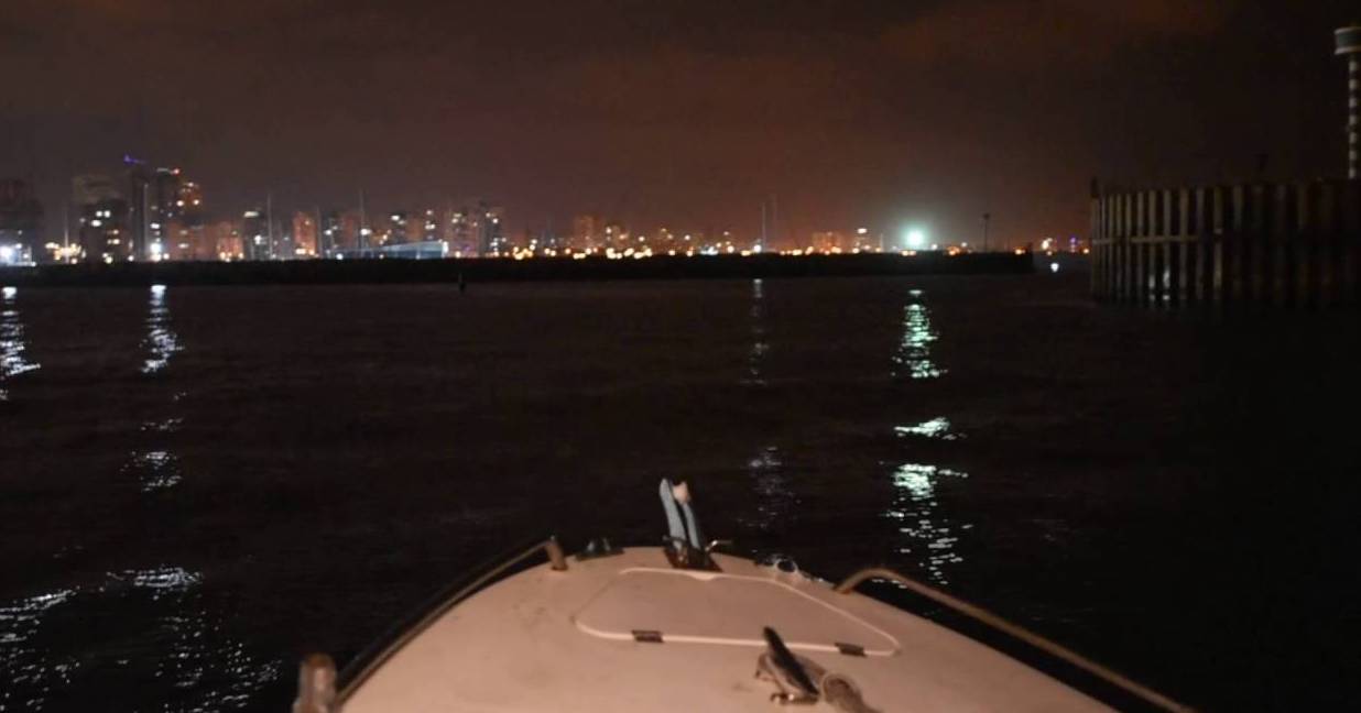 boating at night, approaching coast at night