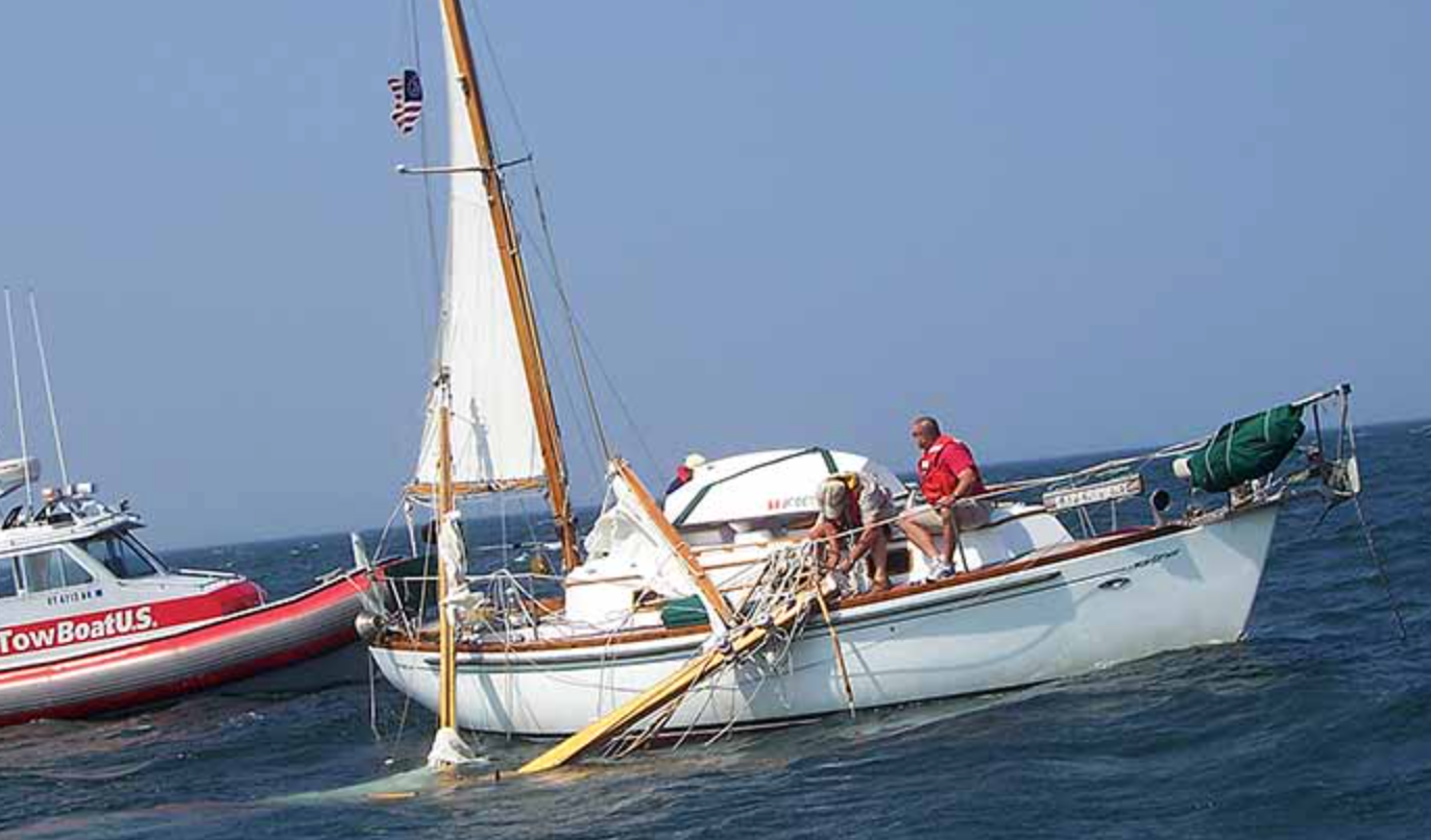 sailboat with broken mast, sailboat needs tow