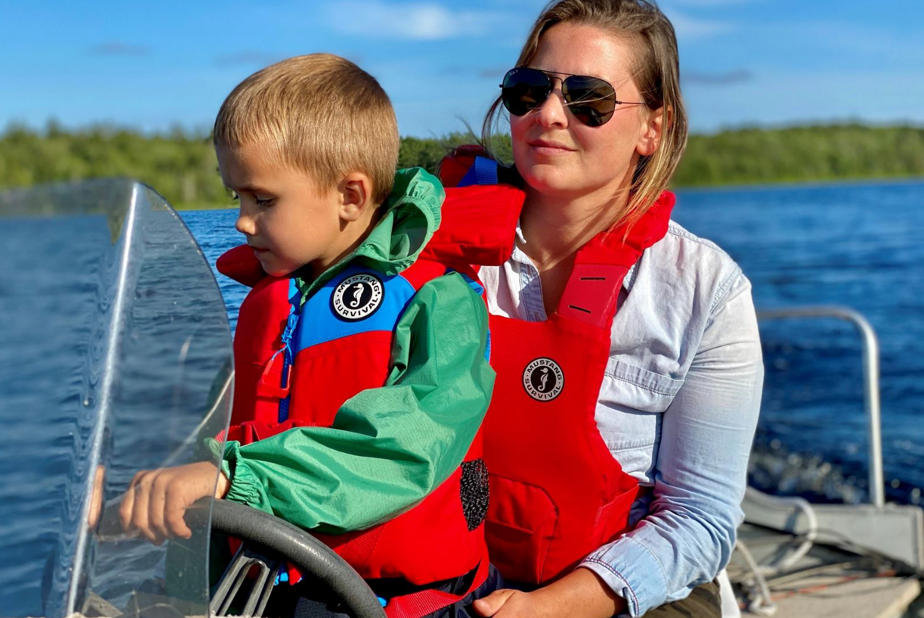 Mother and child lifejackets, mom and son driving boat
