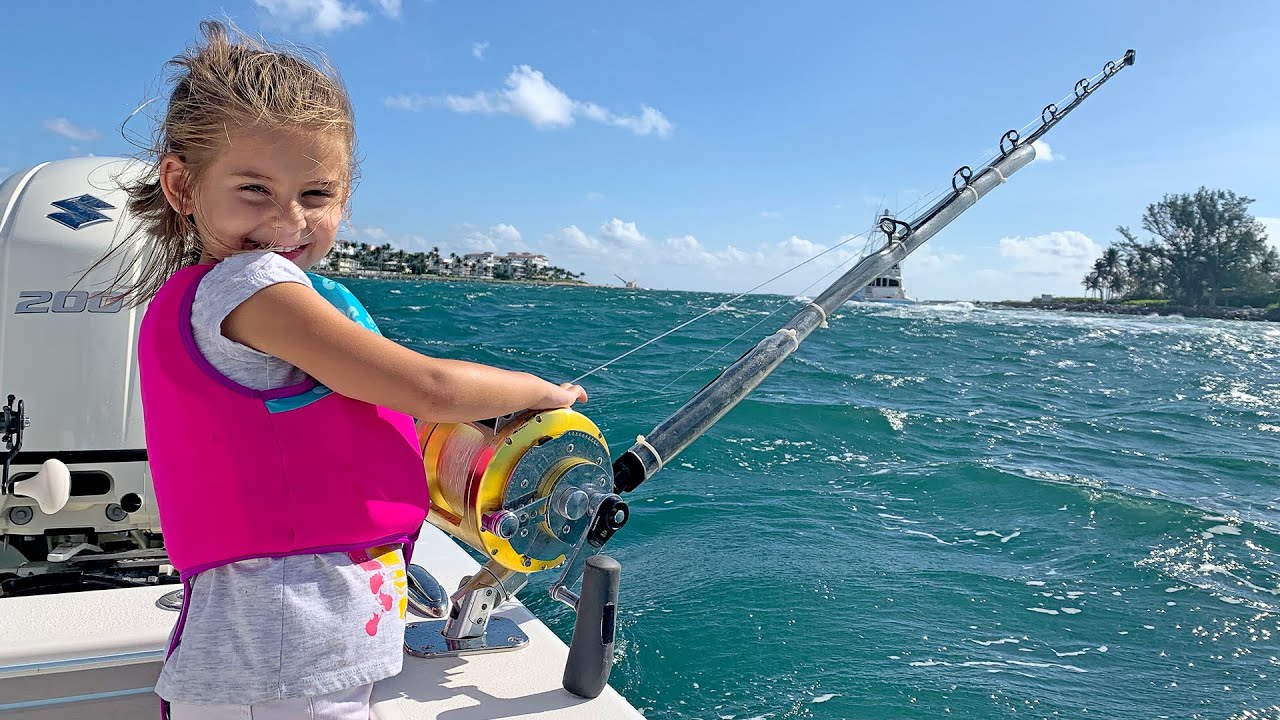 Young girl fishing, taking daughter fishing