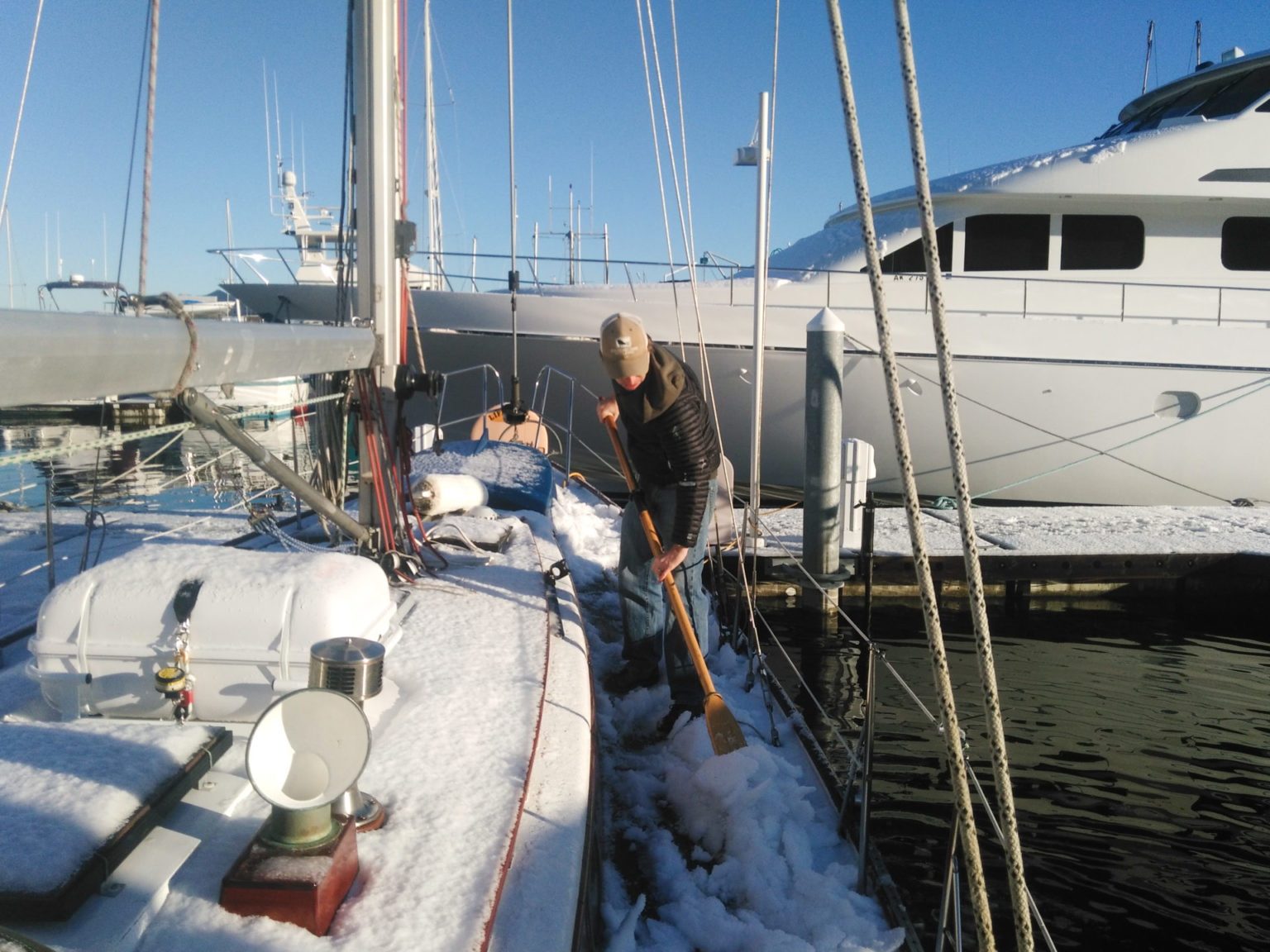 Shoveling snow on boat, winter liveaboard