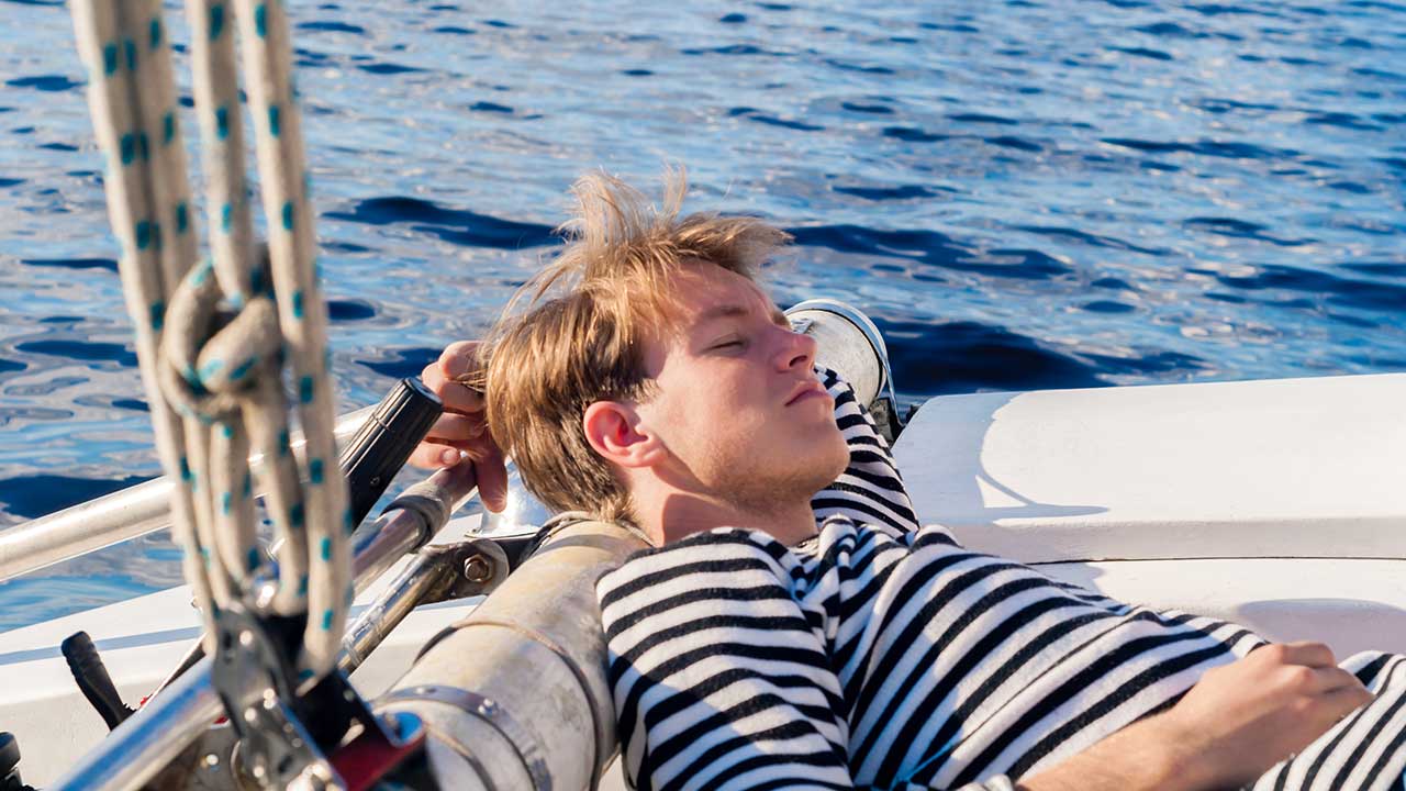 male-sailor-yachtsman-sleeping-snoozing-napping-aft-yacht-ocean.jpg
