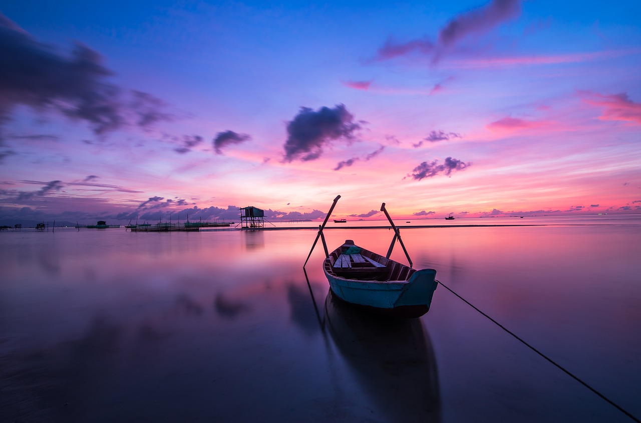 Boat on calm water during sunrise
