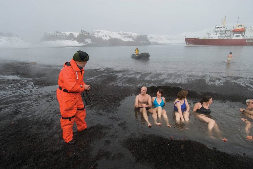 Passengers bathe in the thermal vents at Deception Island, Antarctica