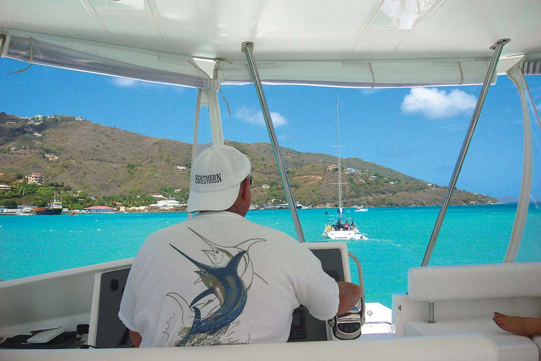 Skip Allen at the helm of the Mooring powercat.
