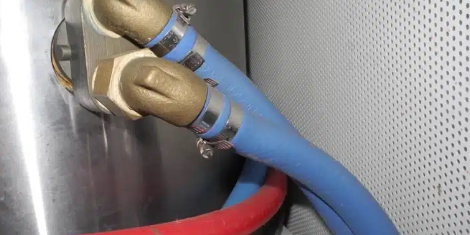 Blue heater hoses bring hot coolant into the water heater tank and return back to the engine after heating the water inside the tank.