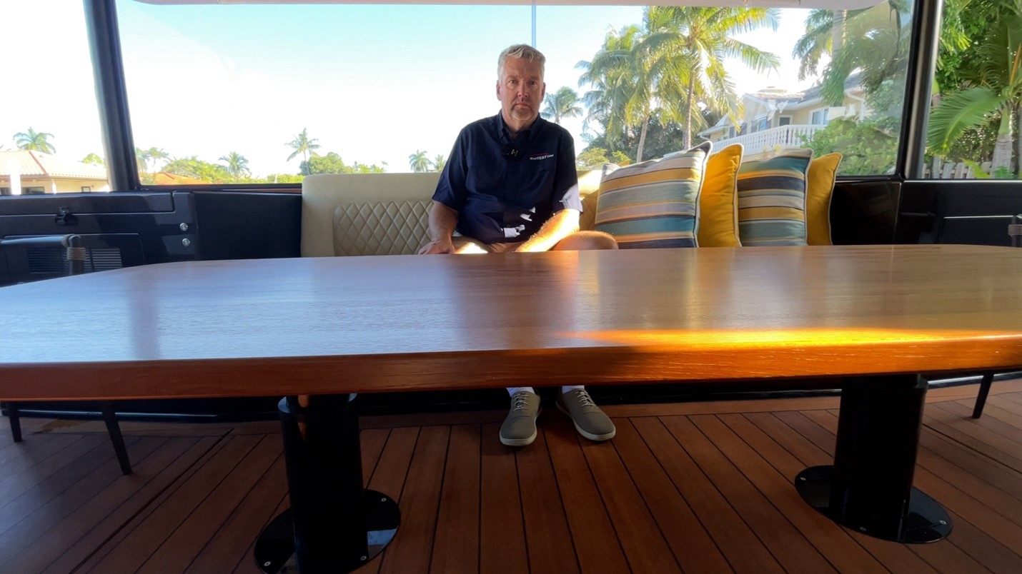 Valder Yachts, The Keys - Cockpit table at minimum height, suitable for cocktails.  Note the table height control buttons just above the table’s edge on the left of the image above