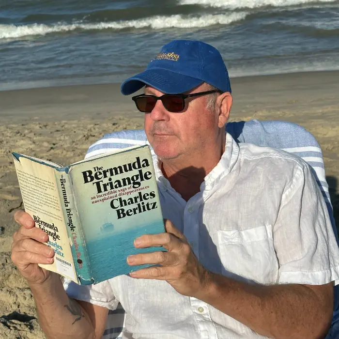 The author with his personal copy of The Bermuda Triangle by Charles Berlitz