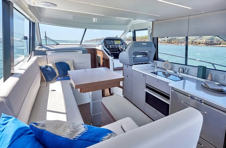 Beneteau's Antares 12 the saloon features a large C-shaped sofa and an adjustable table