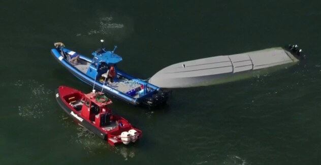 2 tow vessels trying to upright a submerged vessel