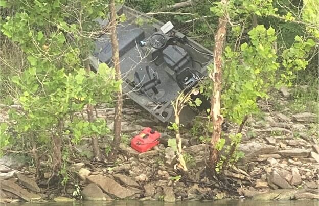 Bass boat in the trees after crashing