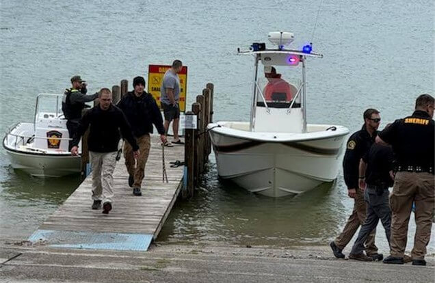 Boat docked with police on the docks