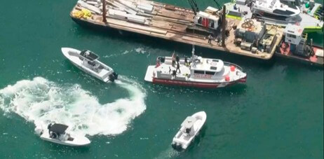 Emergency Vessels Surrounding a barge