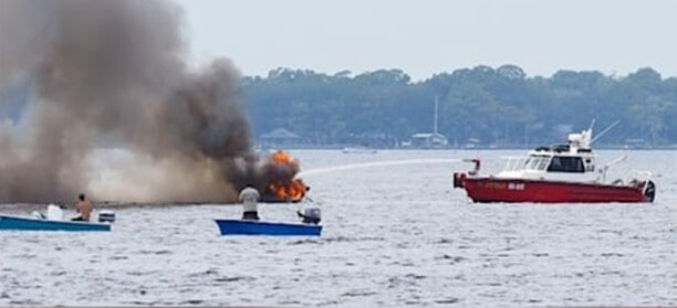 Fireboat putting out a boat on fire