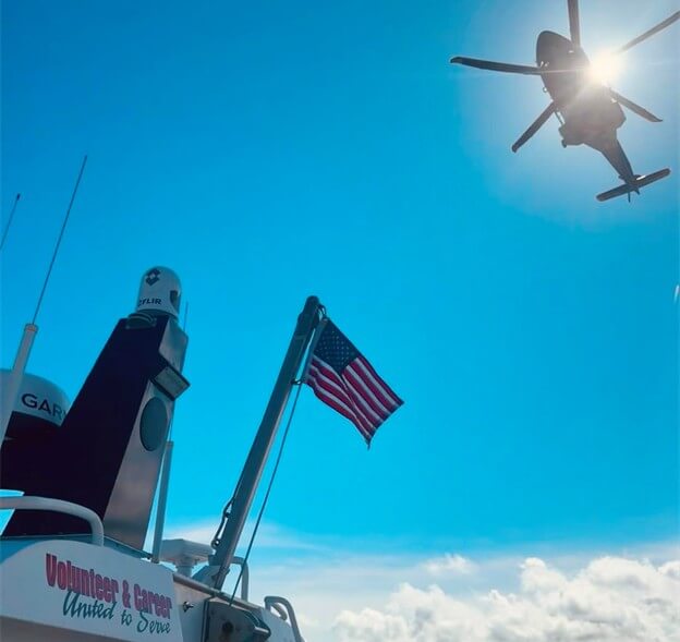 Helicopter airlifiting a person to safety