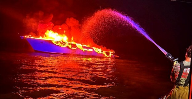 First responders posted a photo of the burning boat lighting up the darkened skies and water