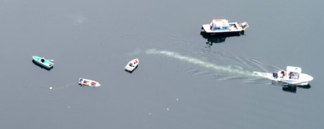 Row boat capsized with recuse boat