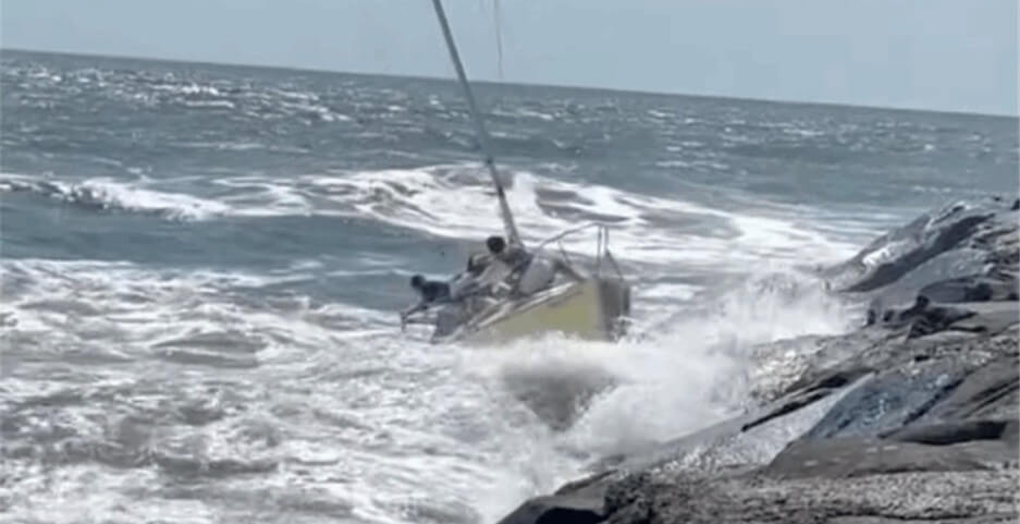 Sail Boat on the rocks in big waves