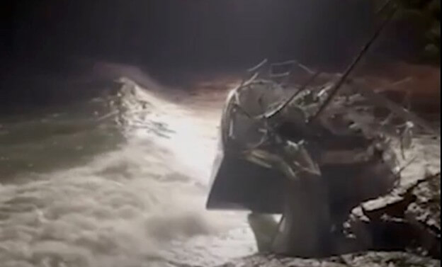 Sailboat on the rocks at night