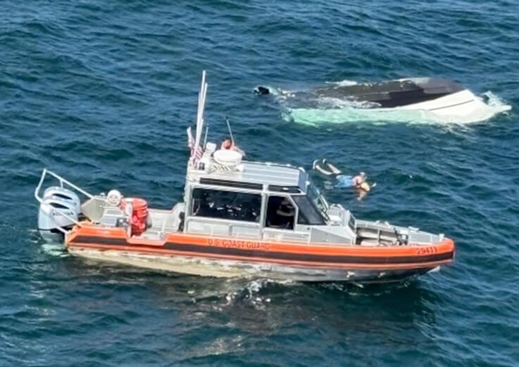 capsized boat and person being resuced