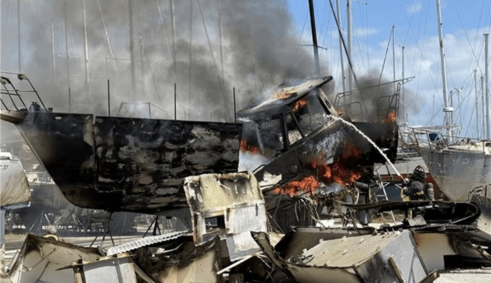 Sailboat on fire in a marina