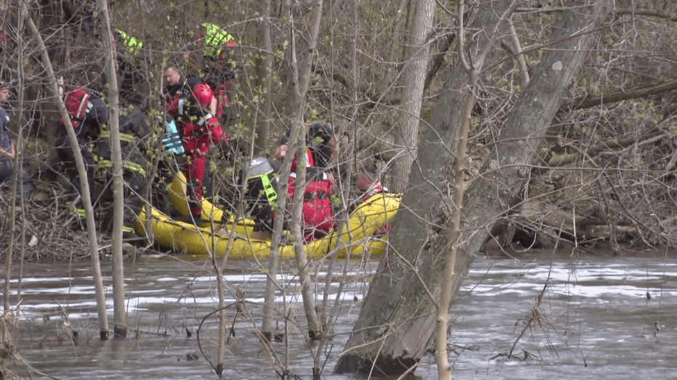 Kayakers being rescued in a river