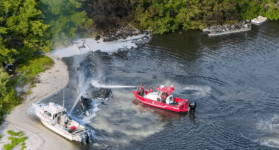 Firefighters putting out fire on a boat