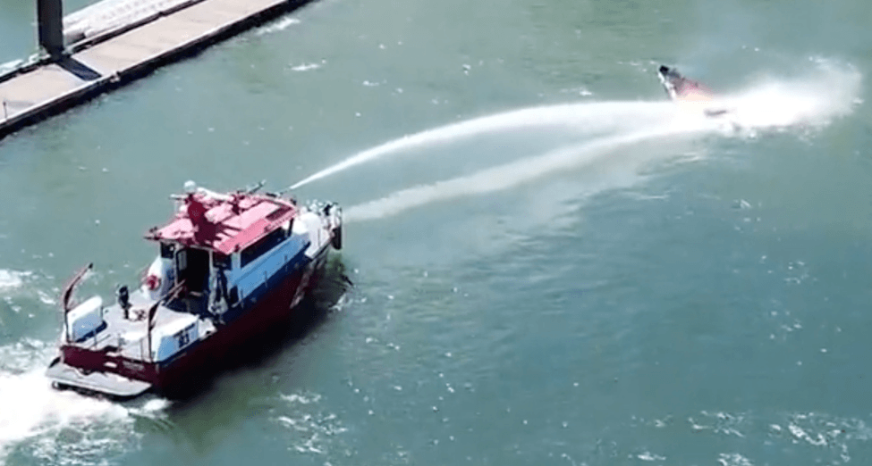 Firefighter putting out a boat fire