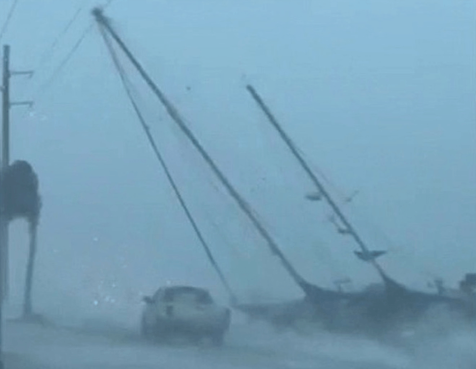 Sailboat tangled in power lines
