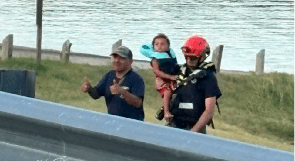 A man holding a rescued baby