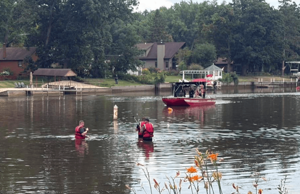 Team of guys searching in a river